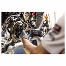 Person working on a motorcycle engine with a Bosch 12V drill